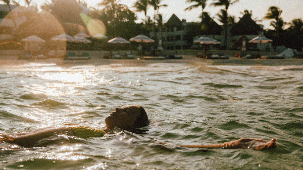 Woman In Sea With Sun Rays