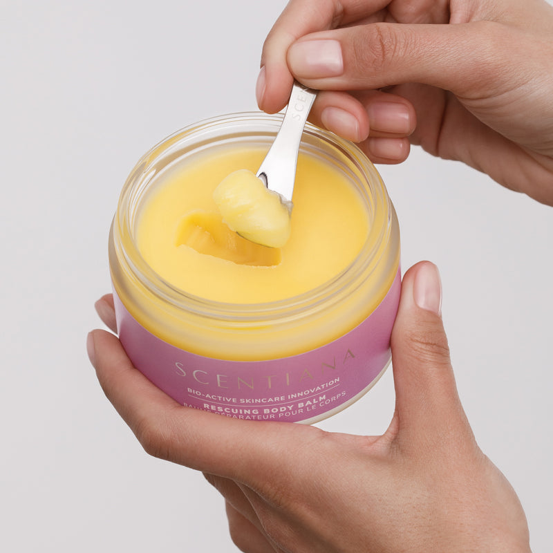 Scooping Yellow Balm Out Of Body Balm Jar