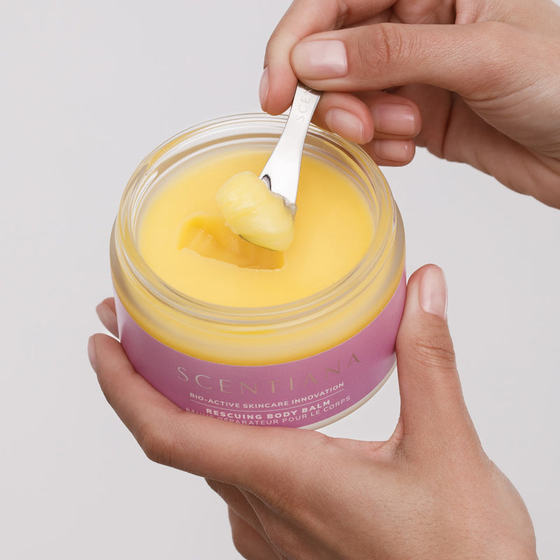 Scooping Yellow Balm Out Of Body Balm Jar