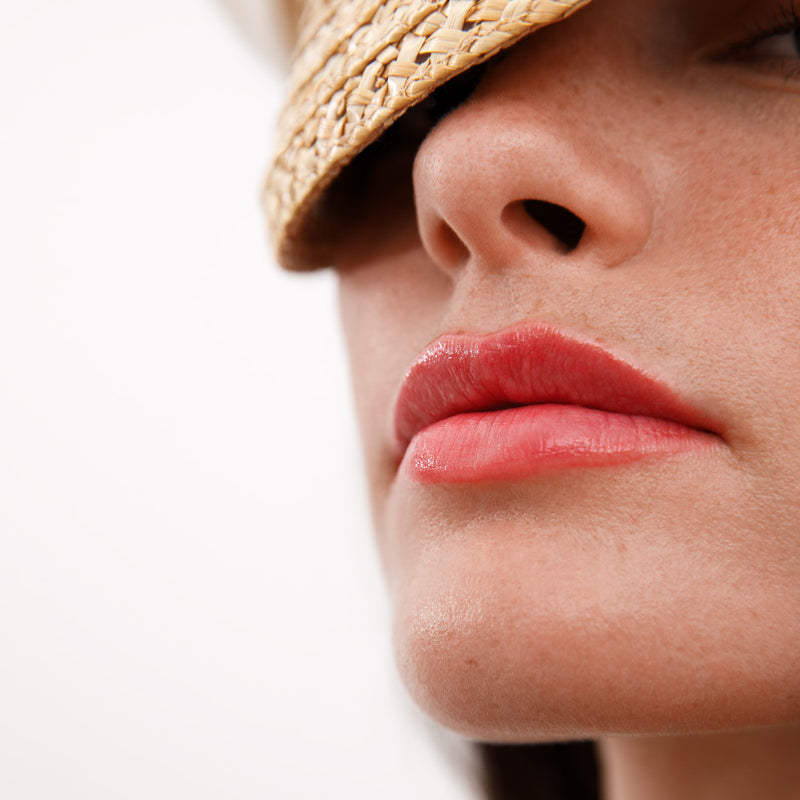 Queenly Lip Blush Glistening On Woman's Lips