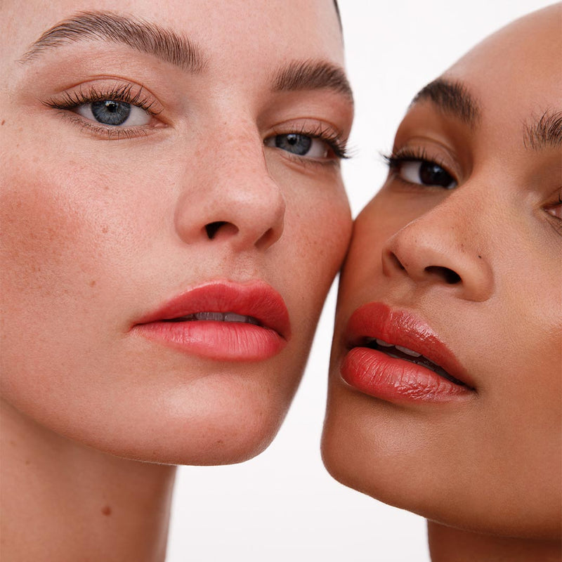 Two women with close-up of their faces, focusing on their nourished lips.