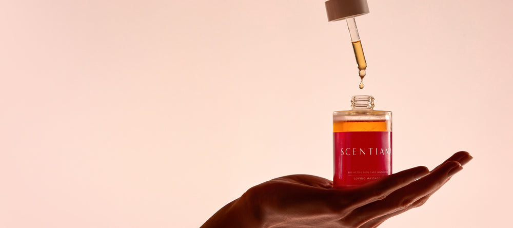 Hand Holding A Bottle And Pipette Of Body Oil