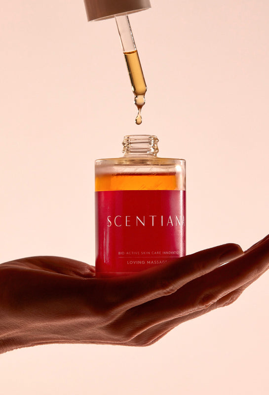 Hand Holding A Bottle And Pipette Of Body Oil