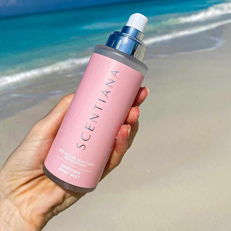 Reviving Face & Body Mist In Hand At The Beach